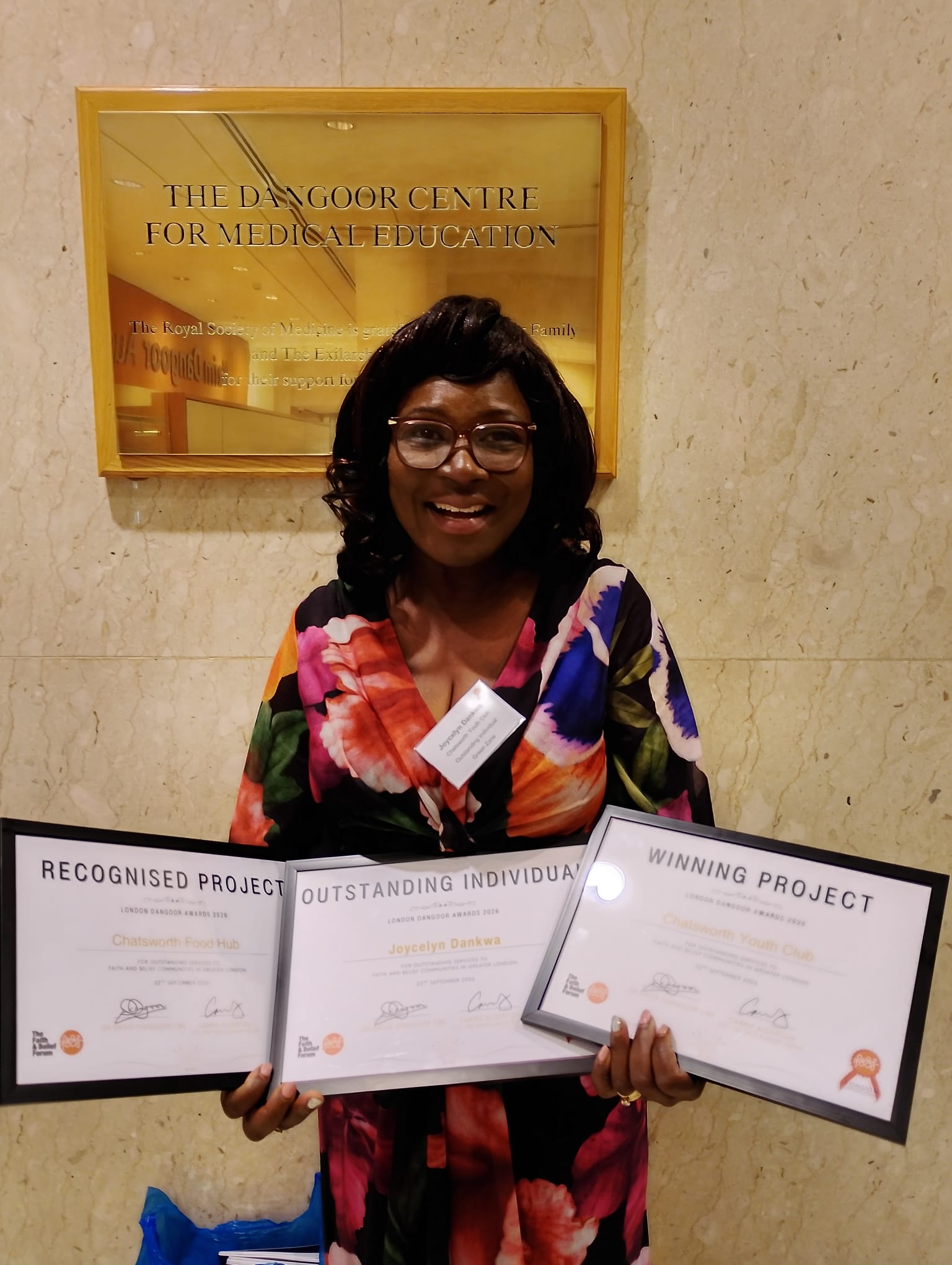 Joycelyn Dankwa holding three London Dangoor Awards 2026 certificates